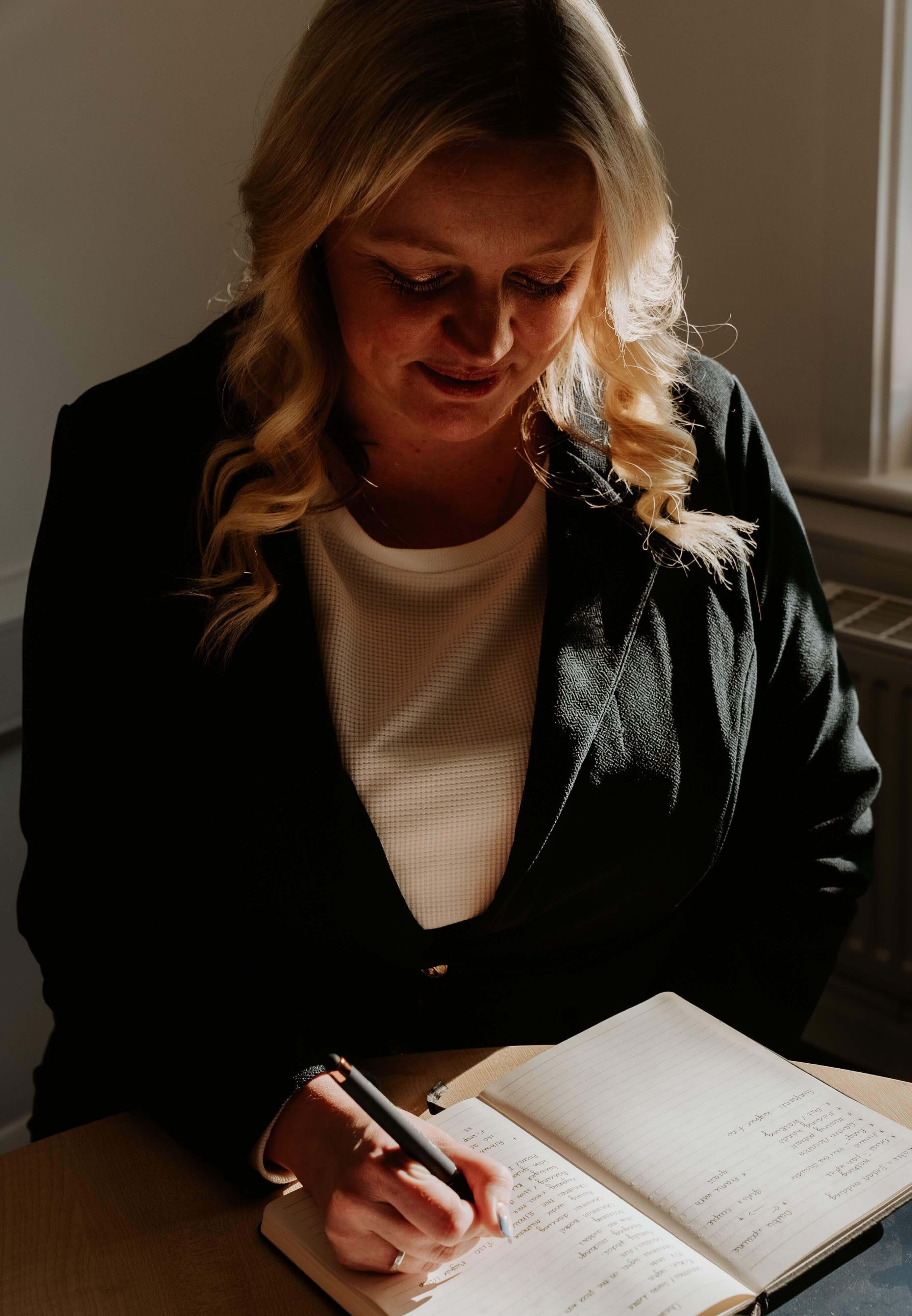 A team member lady writing on a notebook